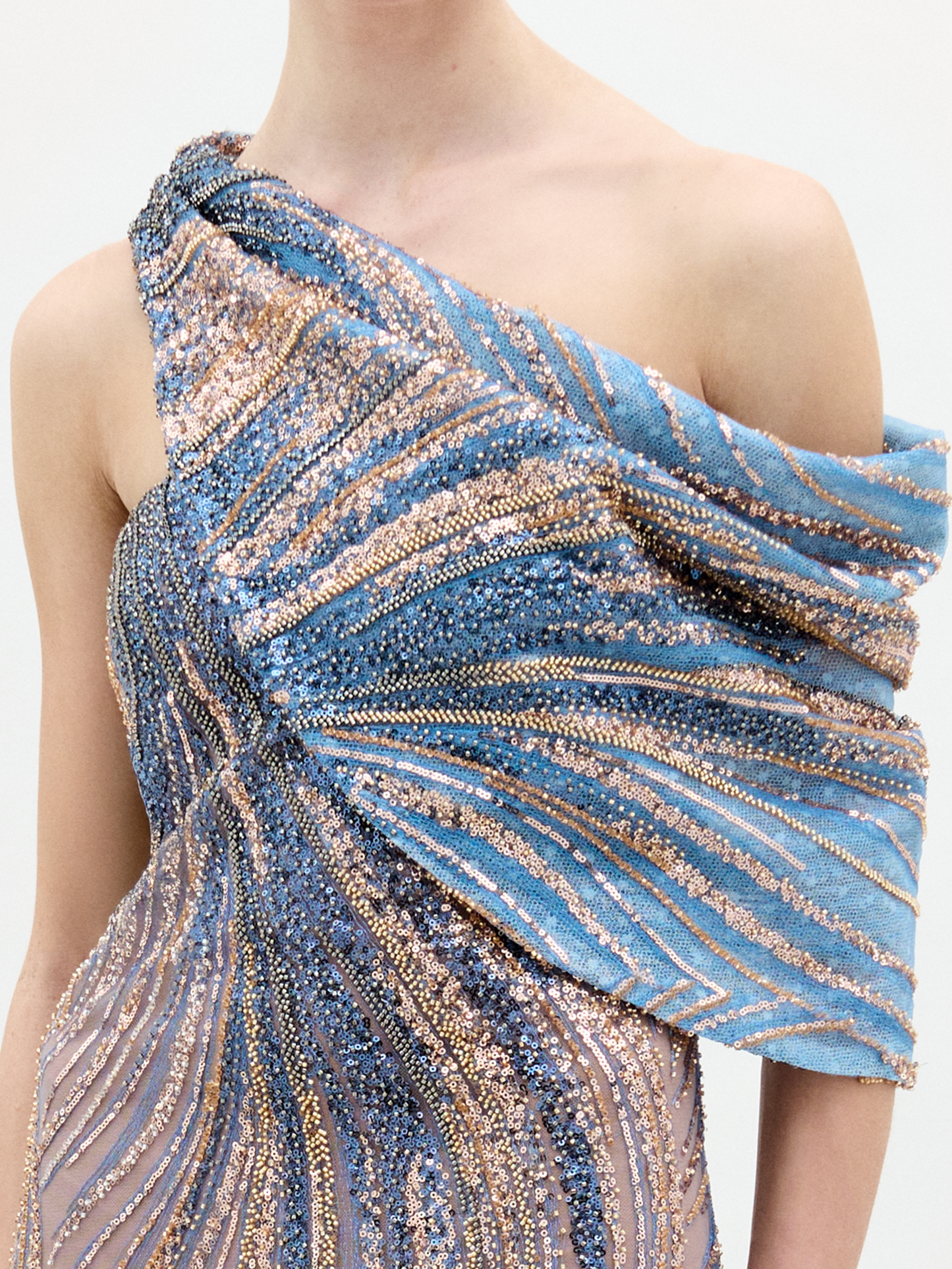 A person stands against a plain background wearing the Rayo de luna dress