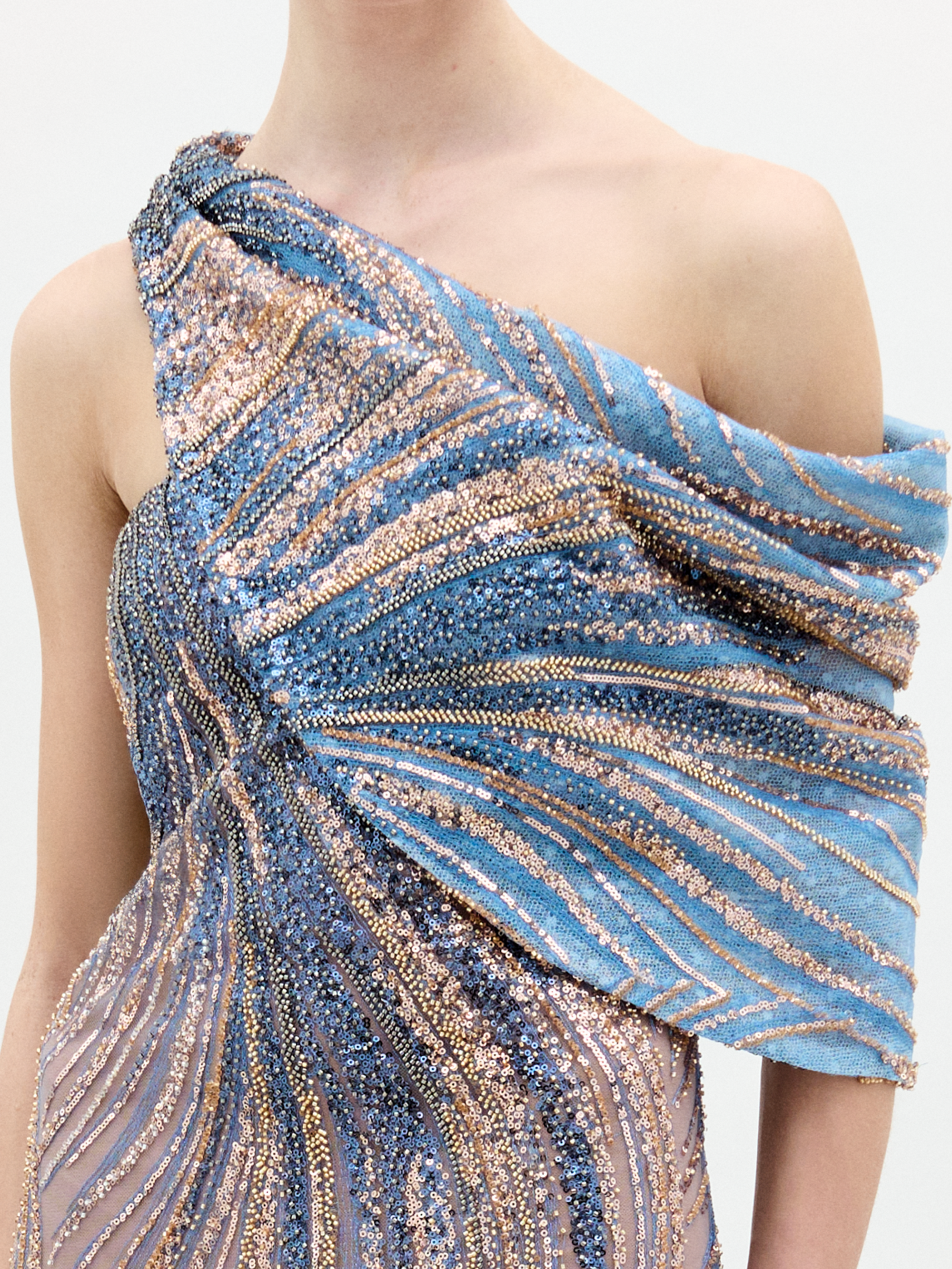 A person stands against a plain background wearing the Rayo de luna dress