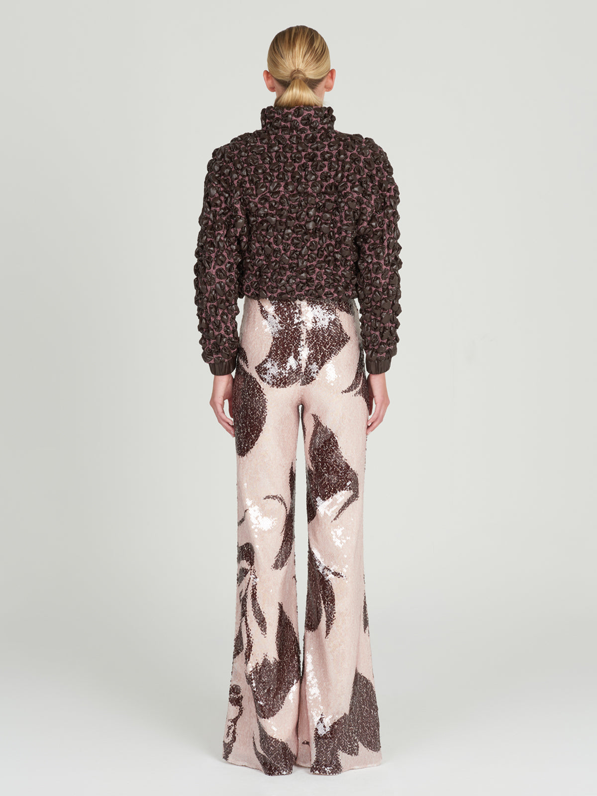 This brown and pink Zalta Jacket Brown features ruffles, perfect for adding a feminine touch to any outfit.