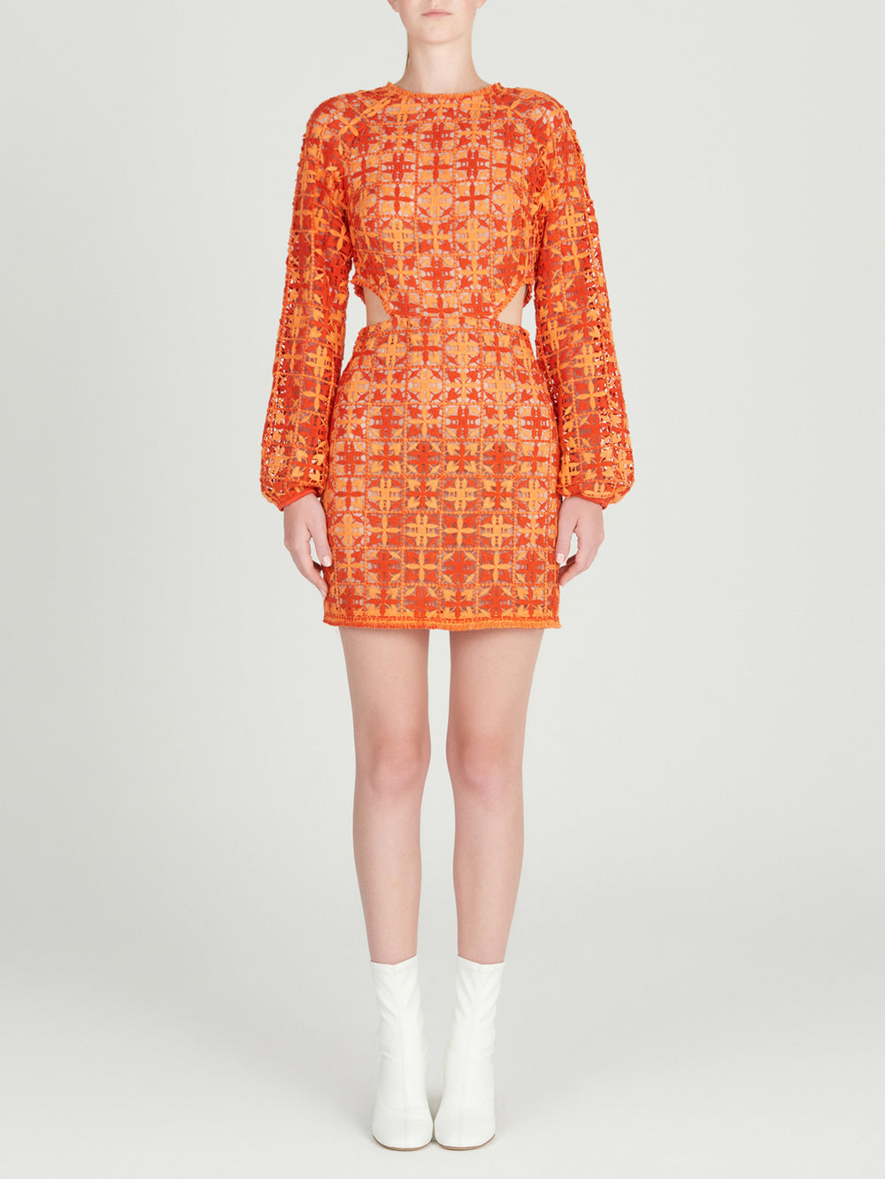 A figure-flattering Janis Dress Red Orange Crochet displayed on a mannequin.