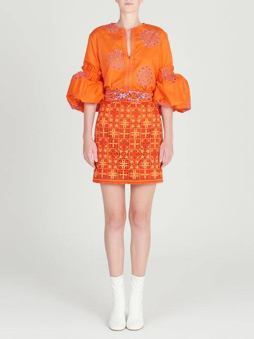 An orange Lucaya Blouse with embroidered sleeves.
Product Name: Lucaya Blouse Orange Lilac Embroidery