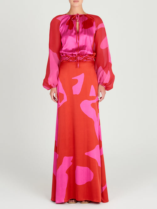 A vibrant Messina Dress Vermillion with floral-inspired red and pink hues, featuring long sleeves.