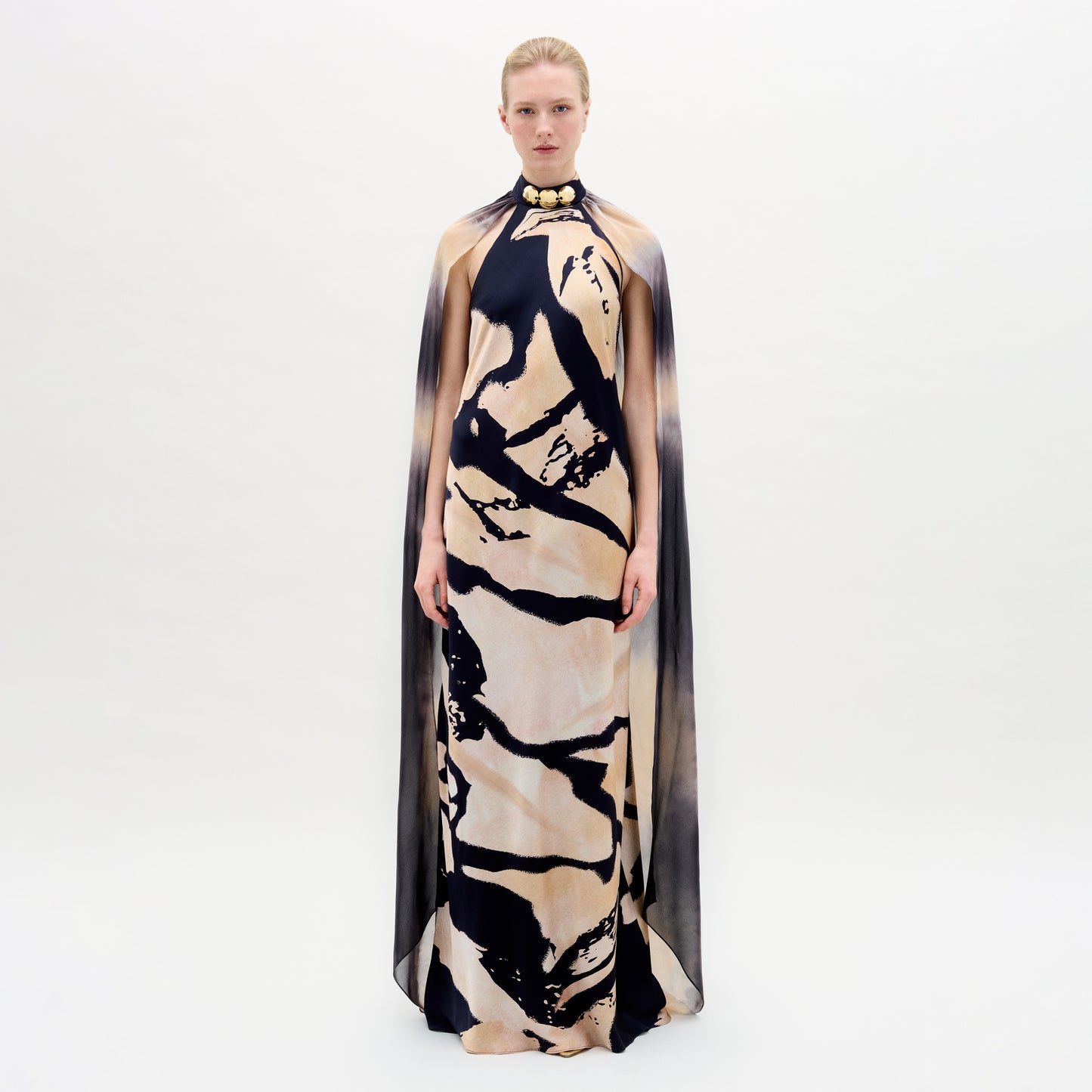 A woman wearing the Sabina Dress in color Black Beige Abstract on a white background.