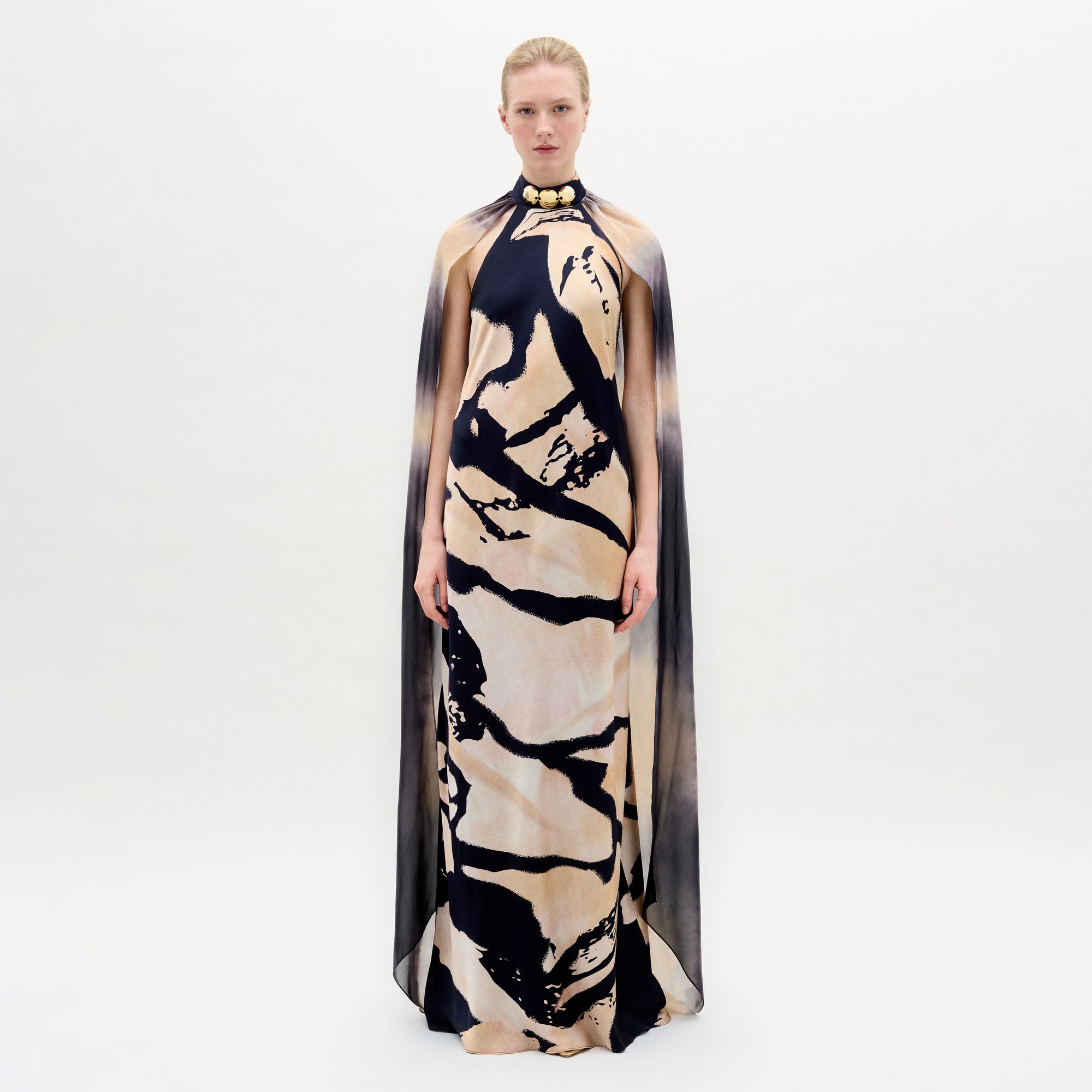 A woman wearing the Sabina Dress in color Black Beige Abstract on a white background.