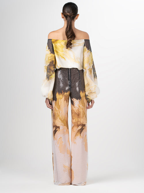 A pair of Avellino Pant Golden Peony with an abstract print.
