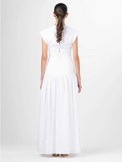 A Hanane Dress White with lace trim and a fitted silhouette.