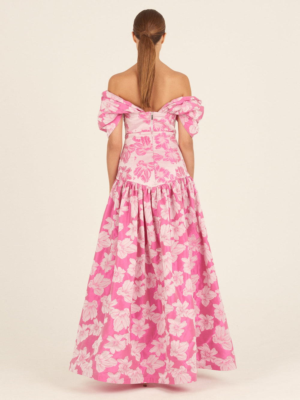 Magenta floral Natasha Top featuring prominent shoulder ruffles against a solid background.