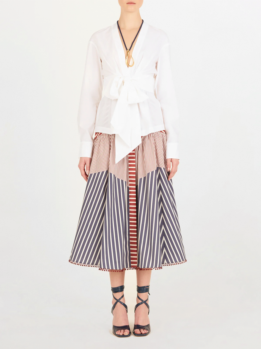 A Saanvi Blouse White with a v-shaped neckline and a bow at the neck.