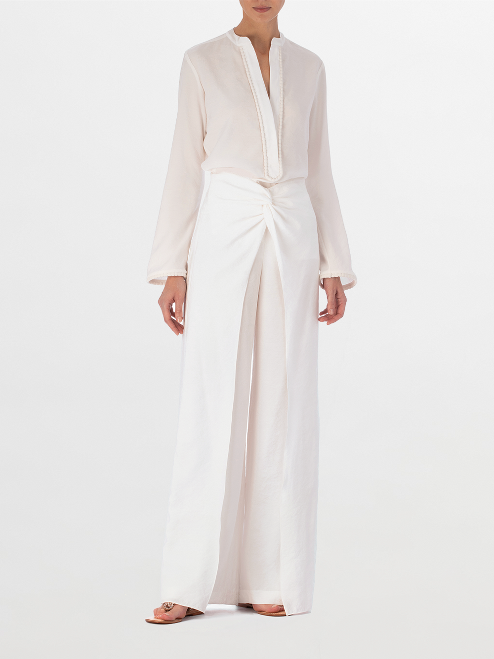 Shera Blouse White with a v-neckline and long sleeves, displayed on a plain background.