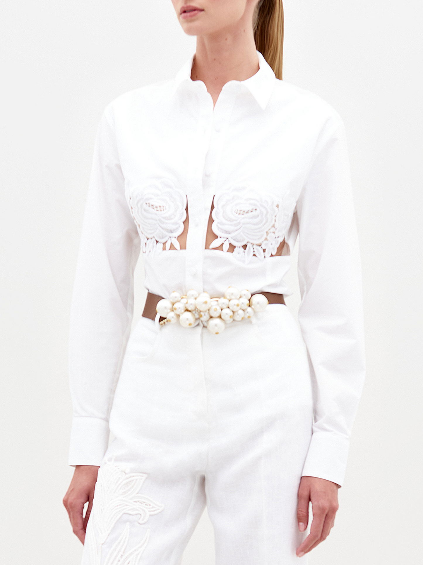 A person stands against a plain background wearing the Sigrid blouse