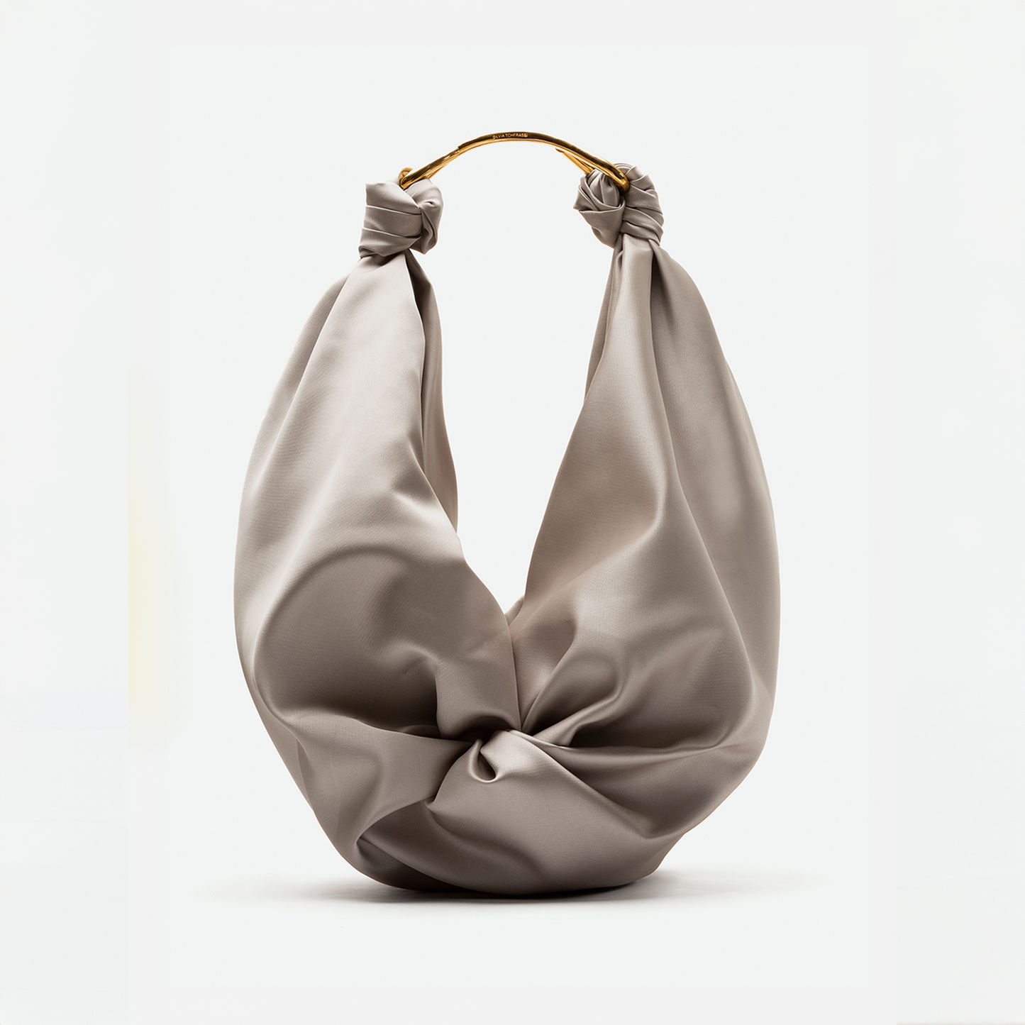 A beige fabric Sofia Bag (Maxi) Beige featuring a twisted knot design and gold metal handles, set to ship by date of November 15th, 2024.