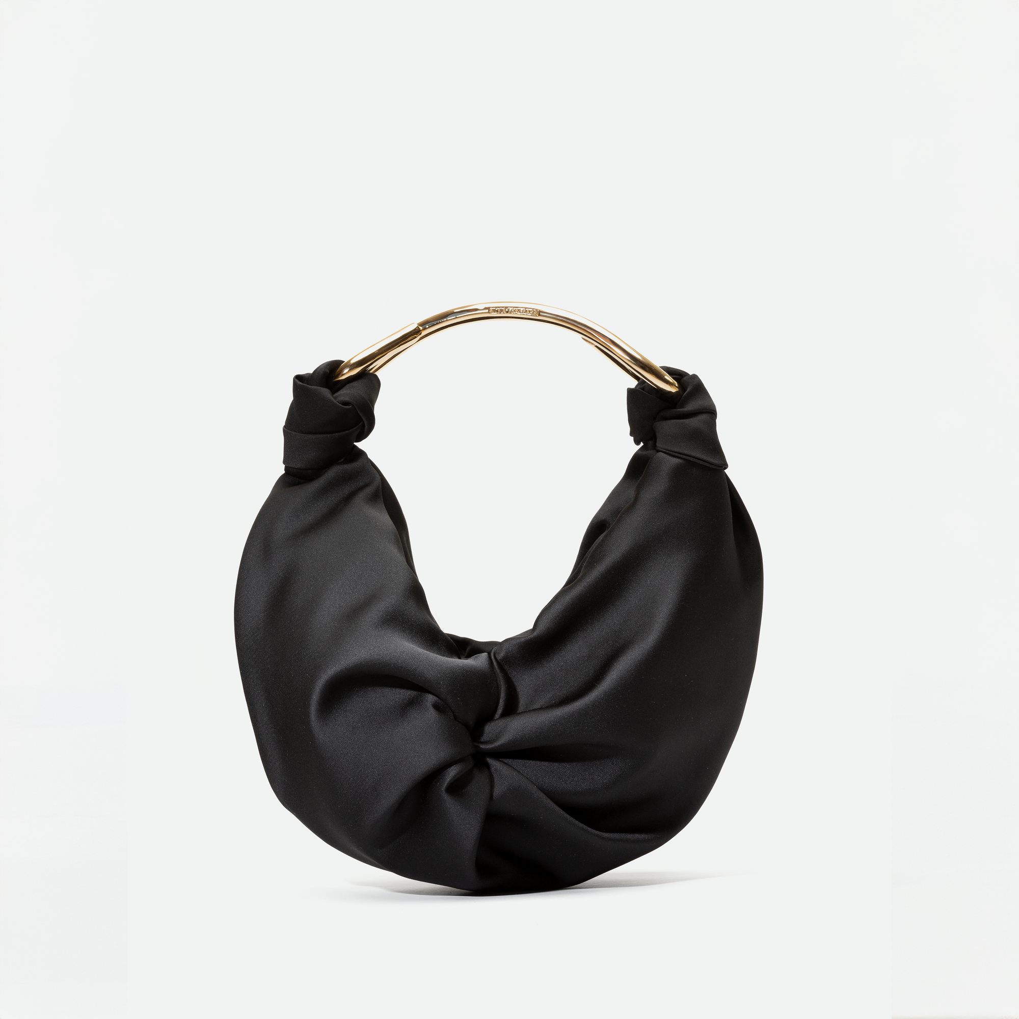 The Sofia Bag (Small) Black features a unique knotted top design and a metallic handle. Available for pre-order now, and it will ship by November 15.