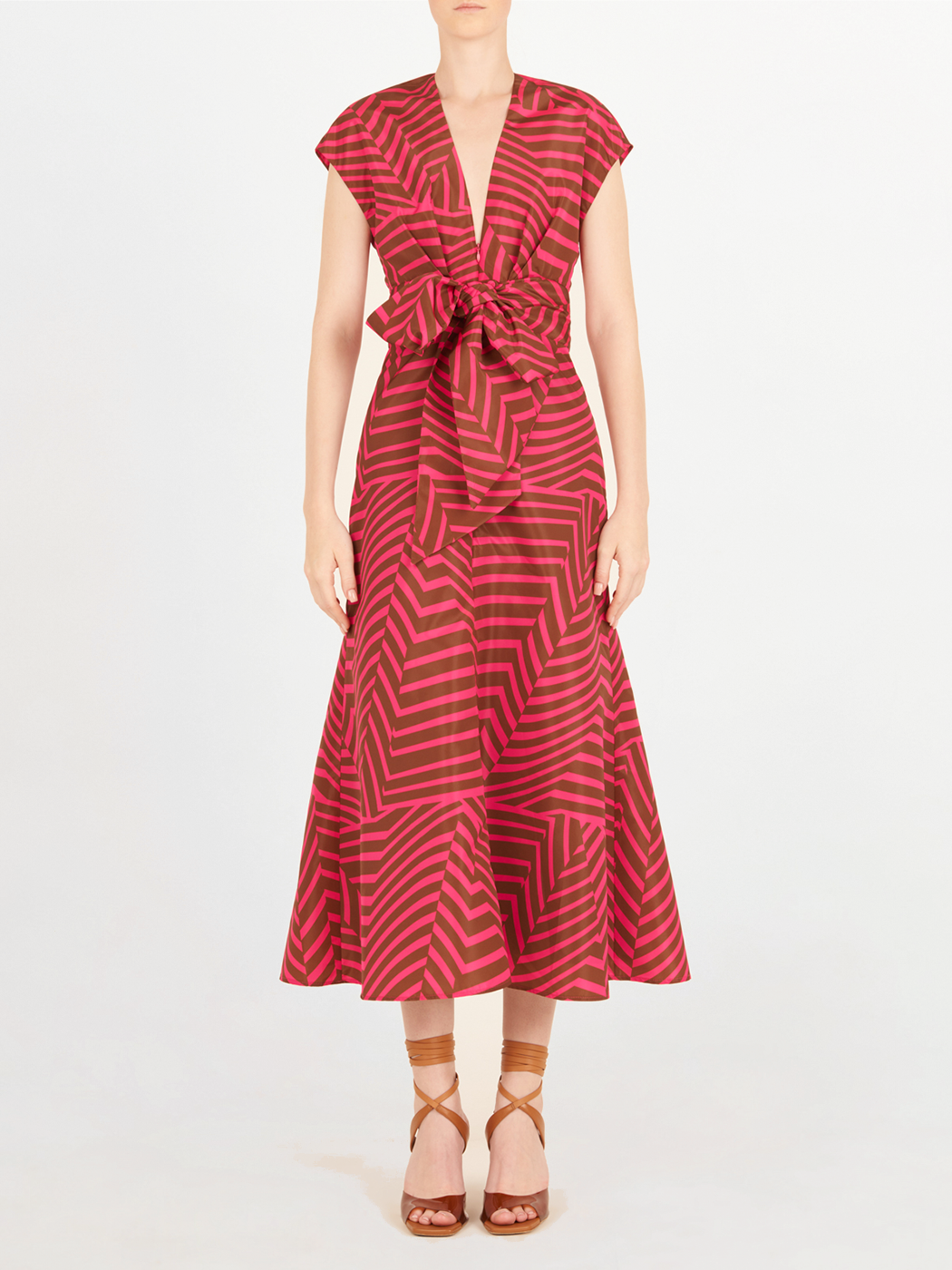 A feminine Toledo Dress Fuchsia Cacao with a bow, perfect for any occasion.