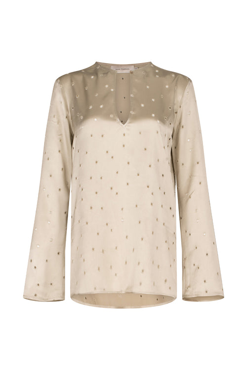 A Tosca Blouse Ecru with a keyhole neckline and gold stars on the fabric texture.