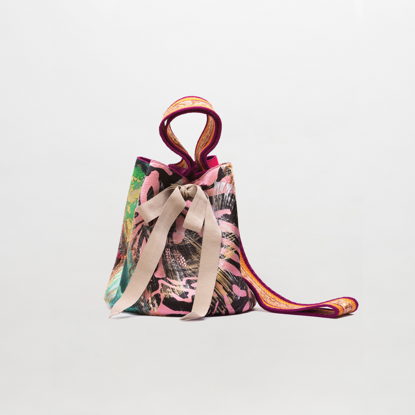 Colorful bucket bag with floral pattern on a light gray background
