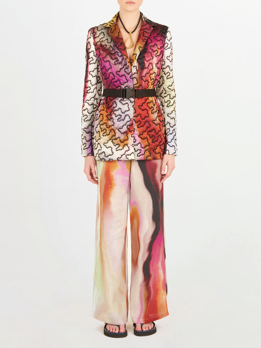 A Yarah Jacket Iridescent Marble with a belt and printed florals.