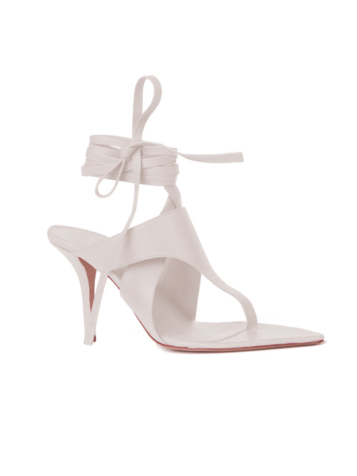 An Italian leather pale pink Domenico Heels White with a strappy design and tie closure around the ankle, isolated on a white background.