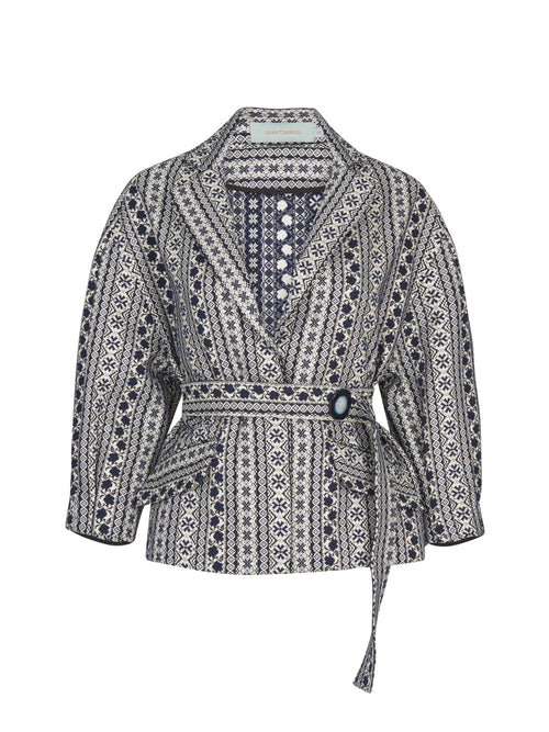 A Gianna Jacket Navy Black in a navy-black mosaic tile print with a waist-cinching belt.