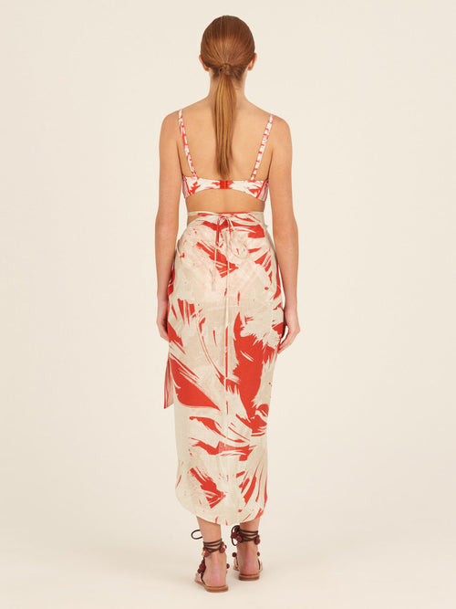 A Alice Skirt Coral Red Palm Print with a bow on it.