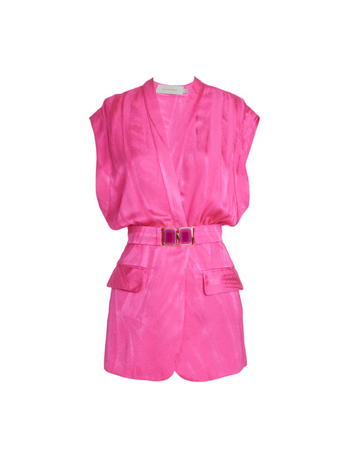 A bright Keith Vest Fuchsia silk jacquard romper with short sleeves, a belted waist, and front pockets, displayed against a white background.