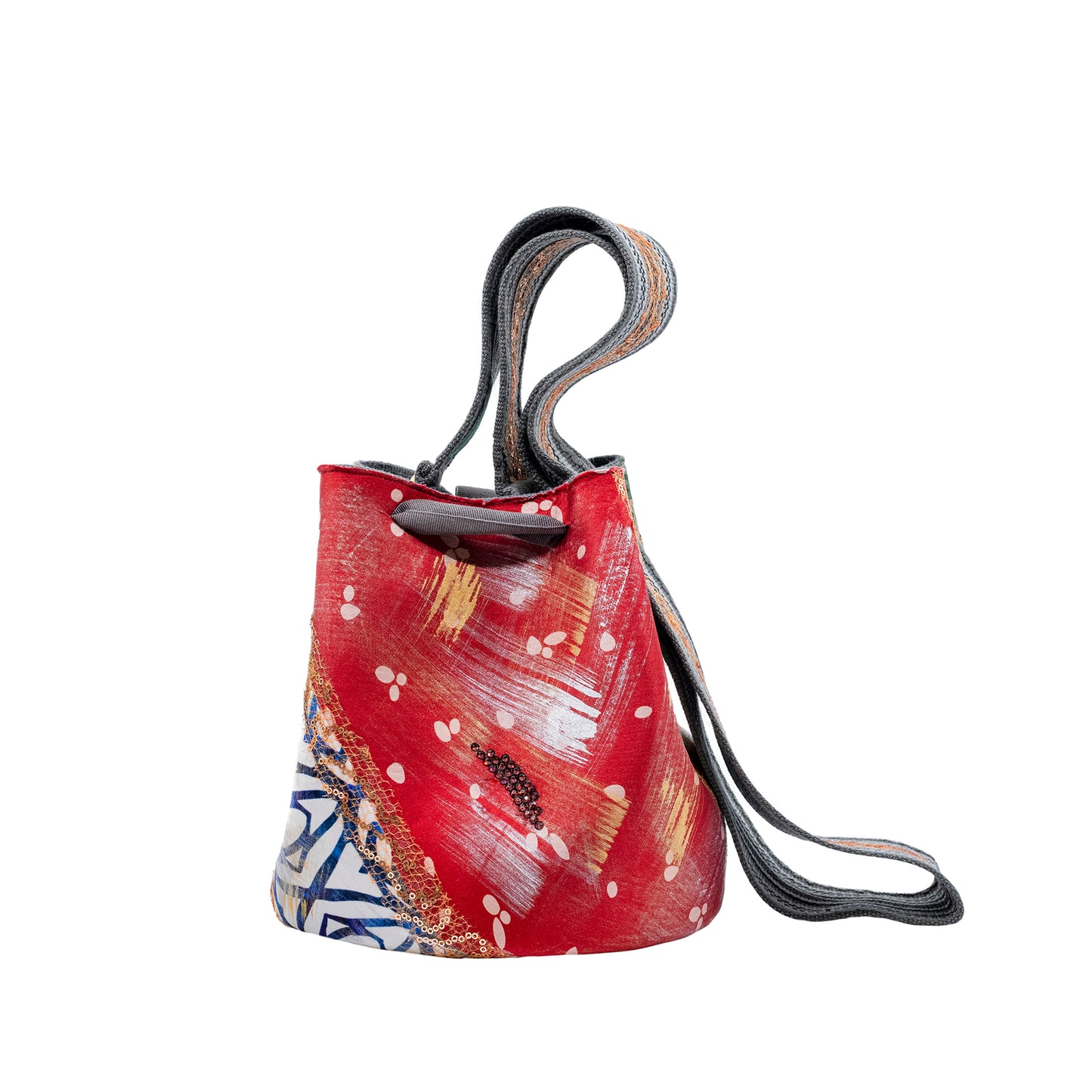 A patterned Mochila Laaput Abstract Grey handbag with a bow, featuring pastel and earth tones on a white background.