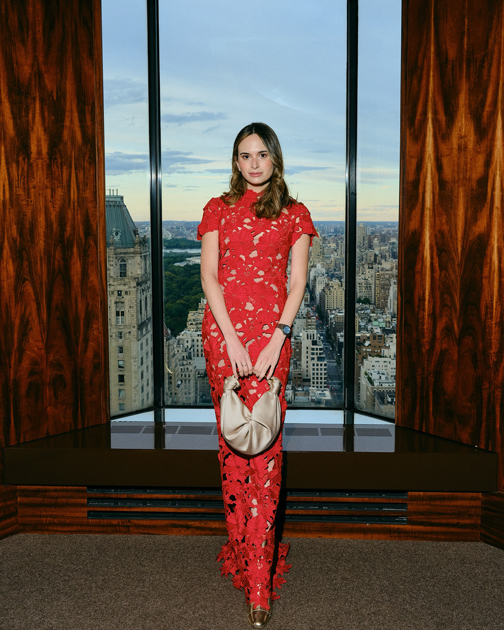 Sofia Tcherassi in a red dress holding the Sofia Bag Beige.