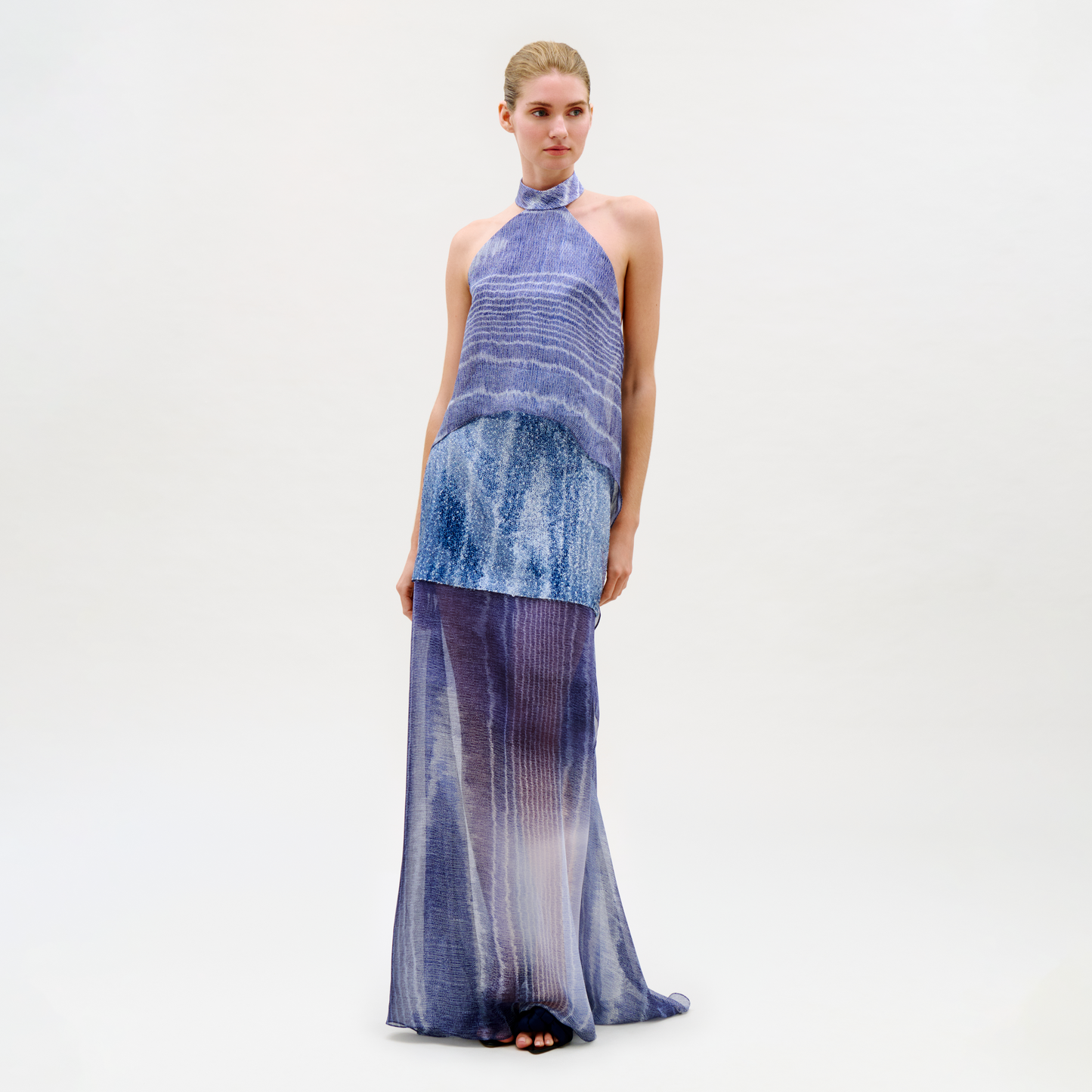 Woman wearing a blue and purple gradient dress on a white background