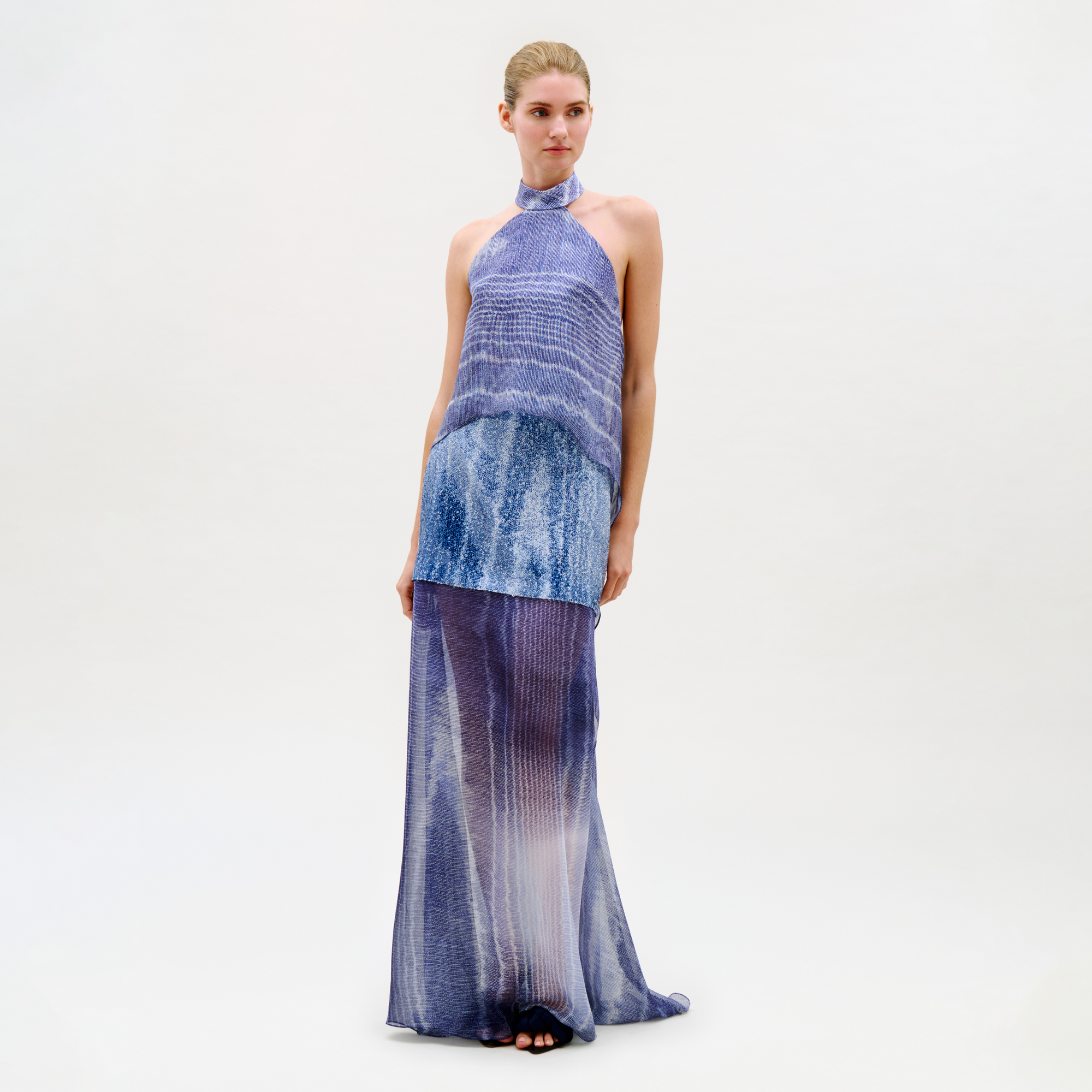 Woman wearing a blue and purple gradient dress on a white background