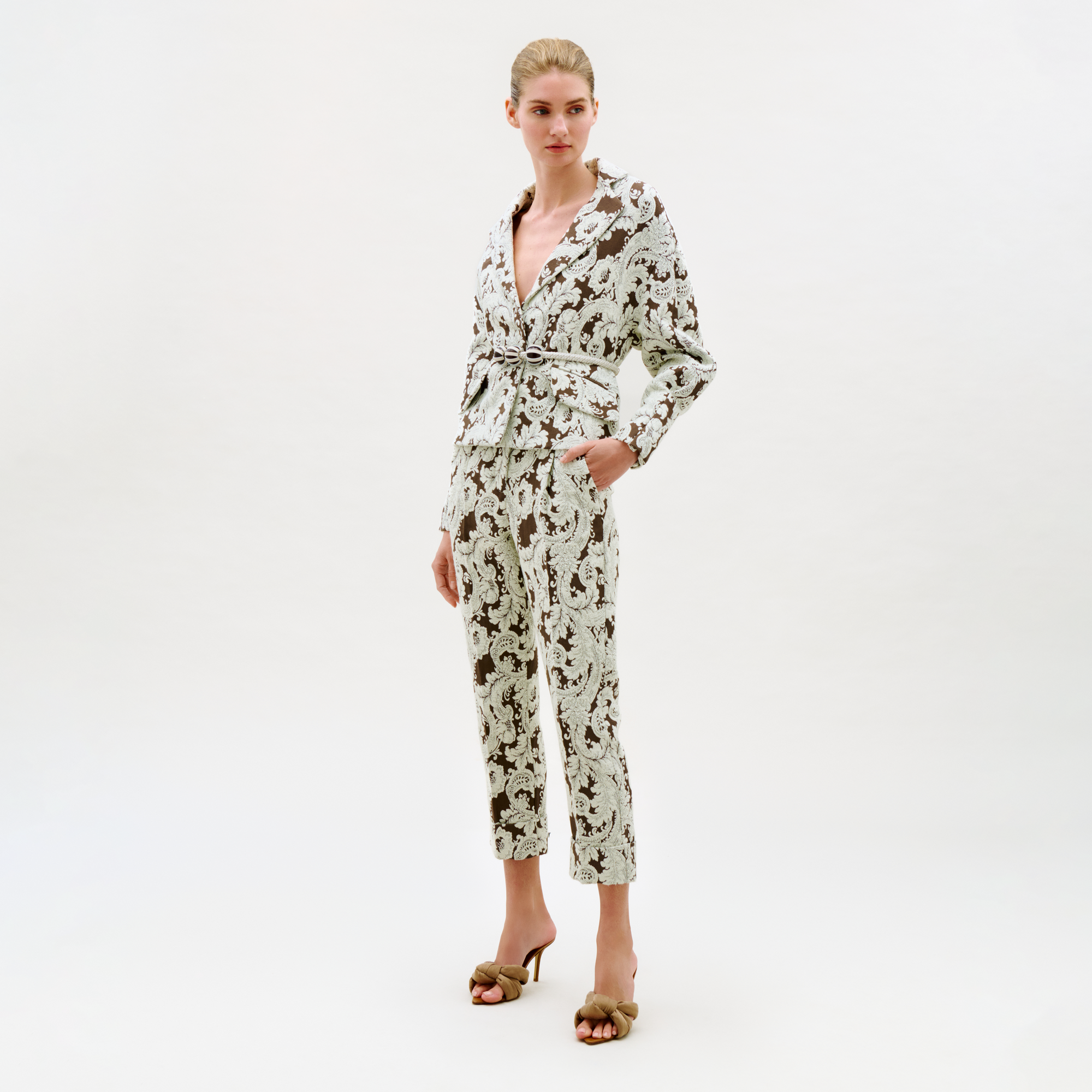 Woman wearing a floral jumpsuit on a white background