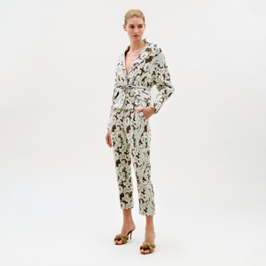 Woman wearing a floral jumpsuit on a white background