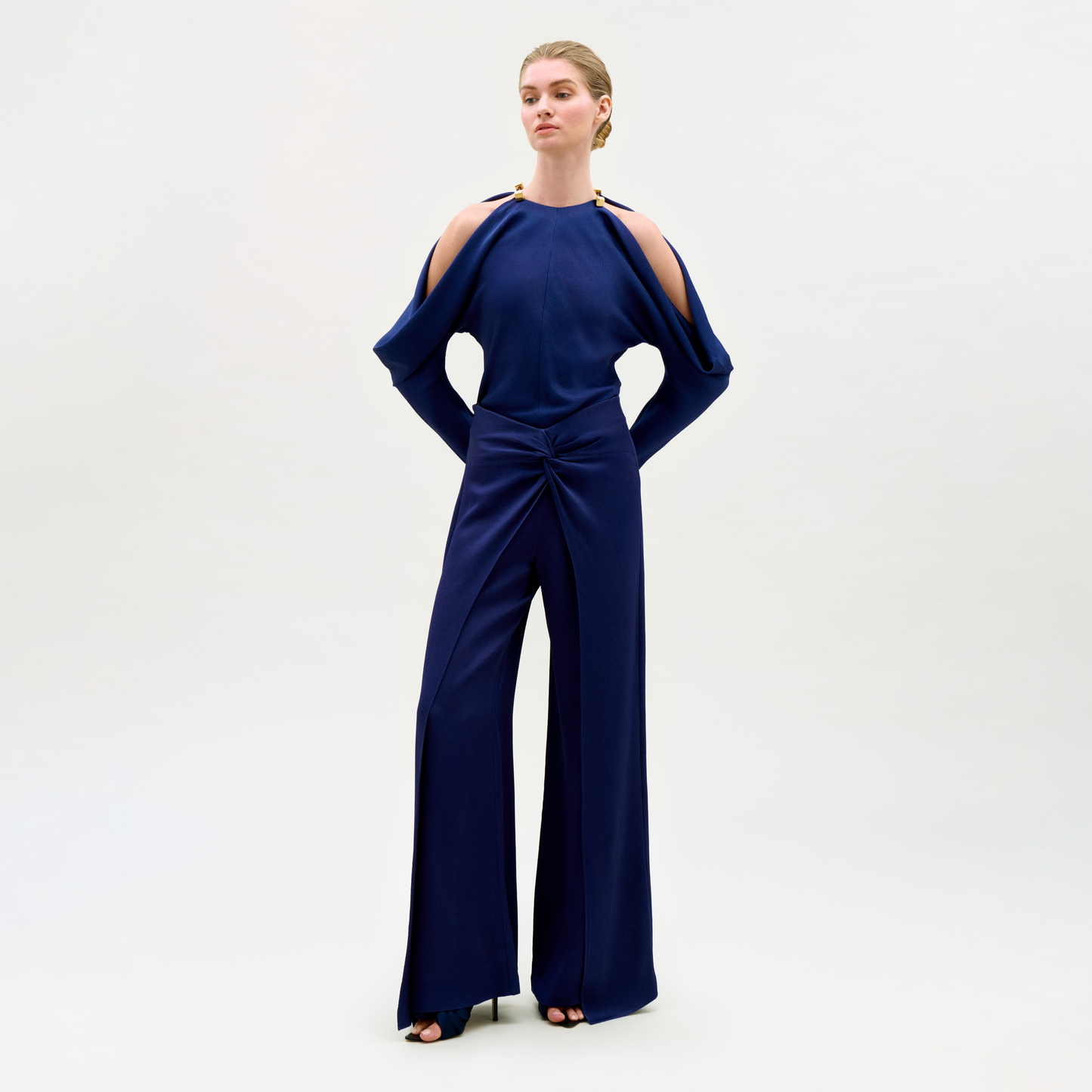 Woman wearing a blue jumpsuit on a white background
