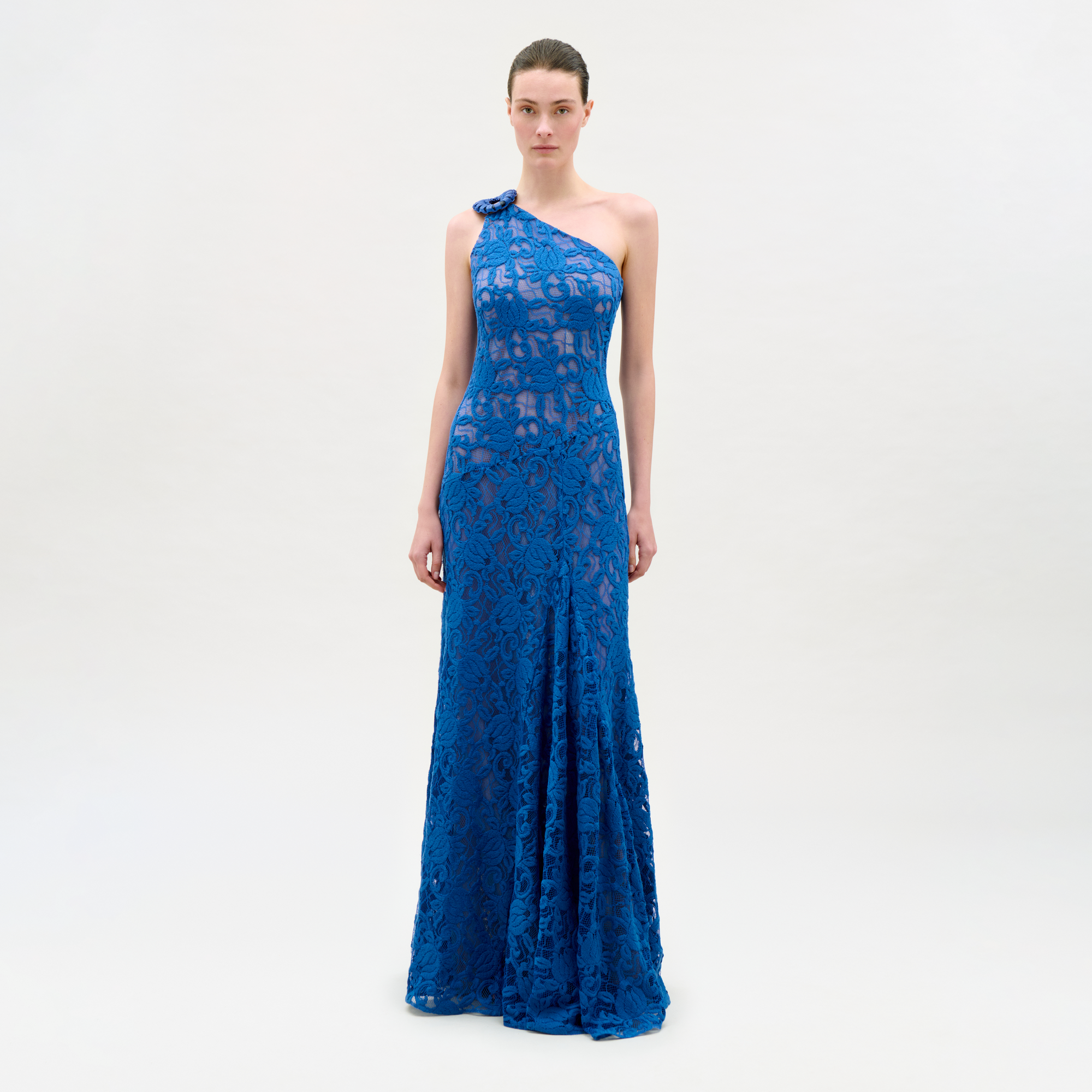 Woman wearing a blue one-shoulder dress on a white background