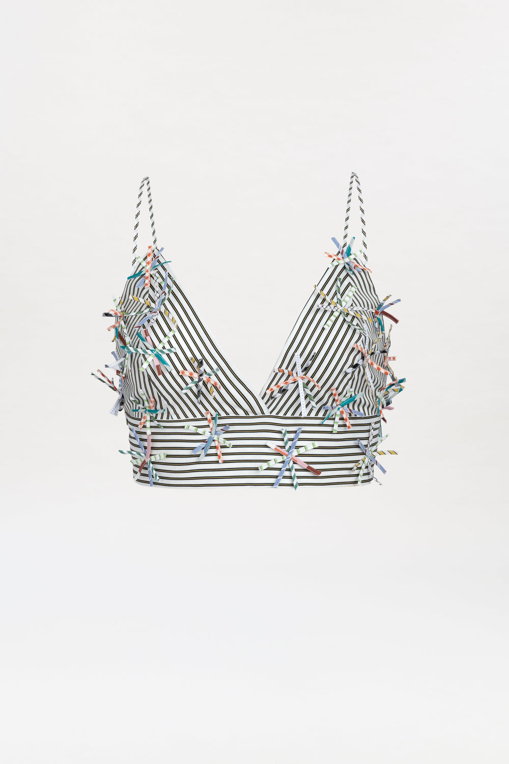 The Ibbie Top, a striped black-and-white crop top with thin straps and colorful embroidered embellishments scattered across the fabric, is displayed on a white background.
