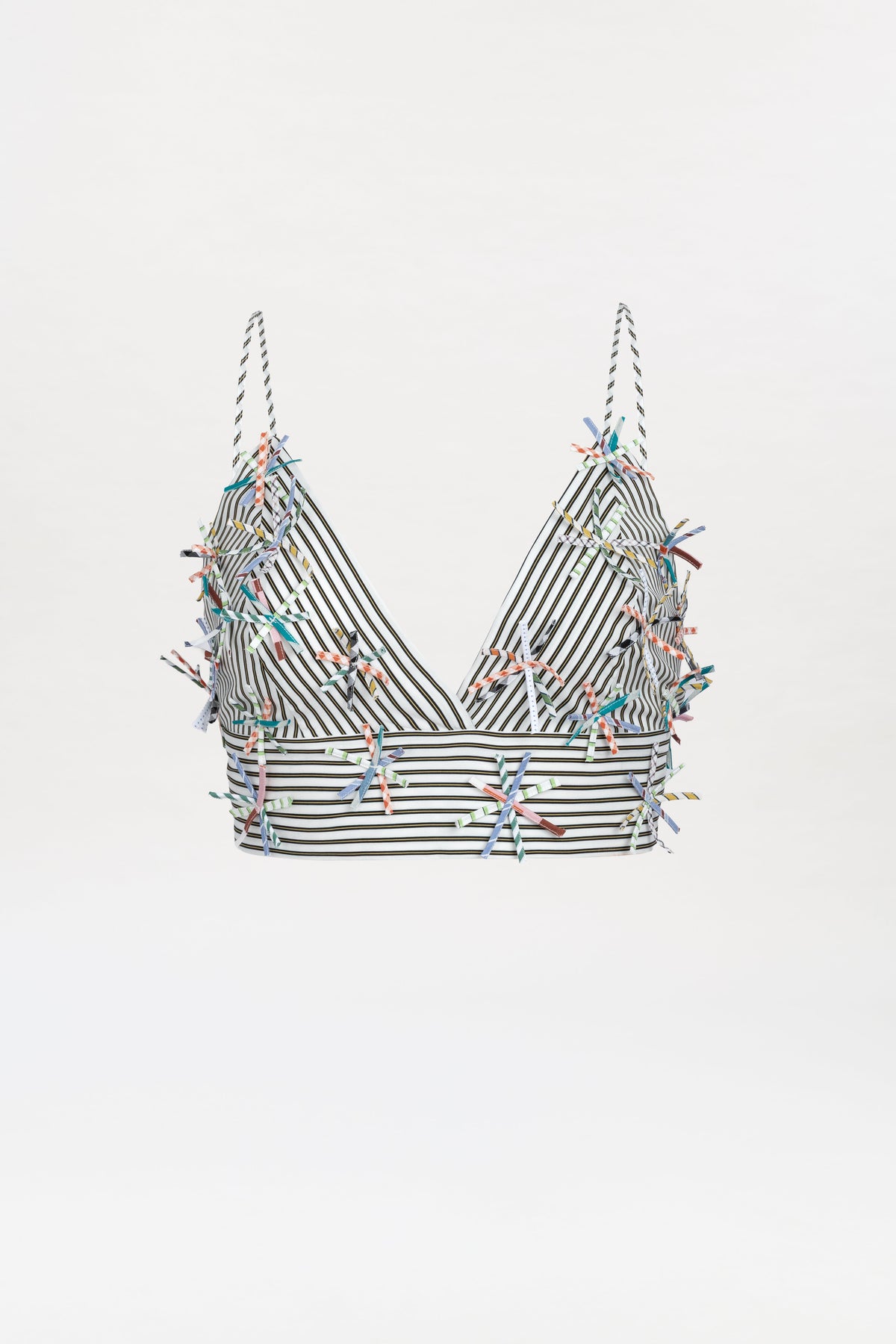 The Ibbie Top, a striped black-and-white crop top with thin straps and colorful embroidered embellishments scattered across the fabric, is displayed on a white background.