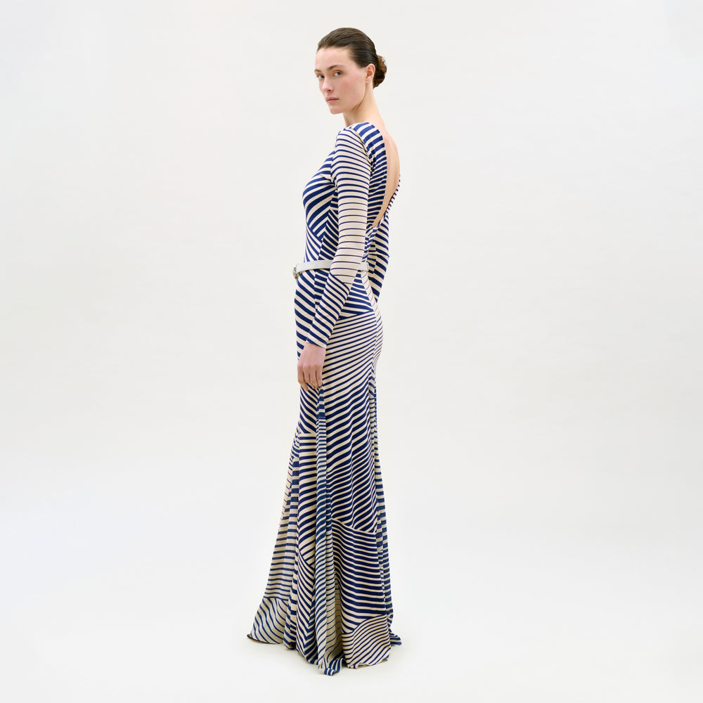 Woman wearing a long, striped dress on a white background