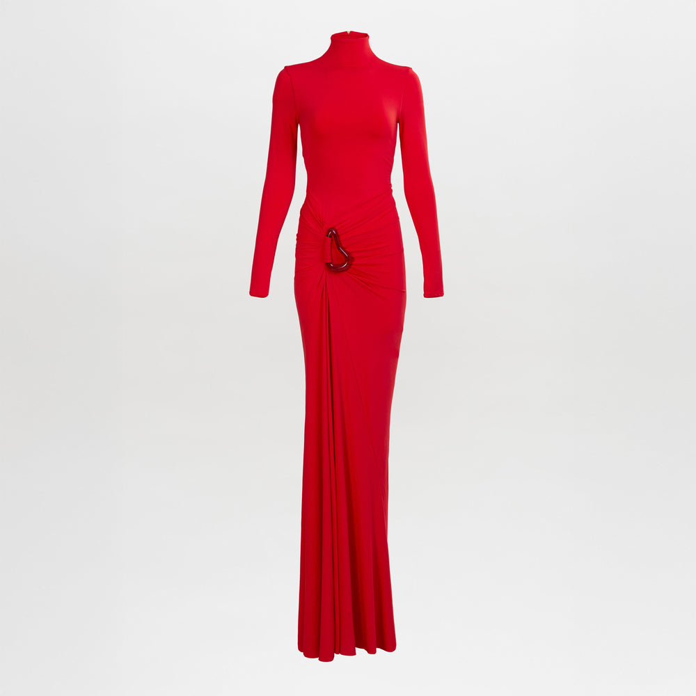 The Lena Dress is a long-sleeved, floor-length red gown with a high neckline, ruched waist detail, and metallic embellishment.