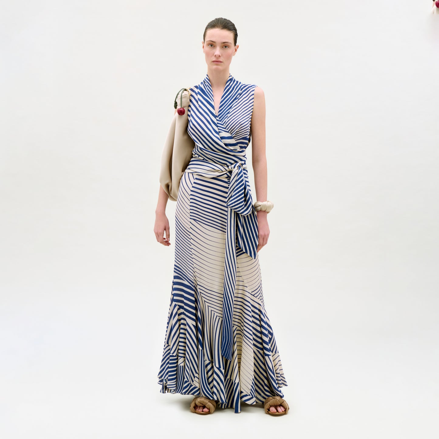 Woman wearing a blue and white striped dress on a white background