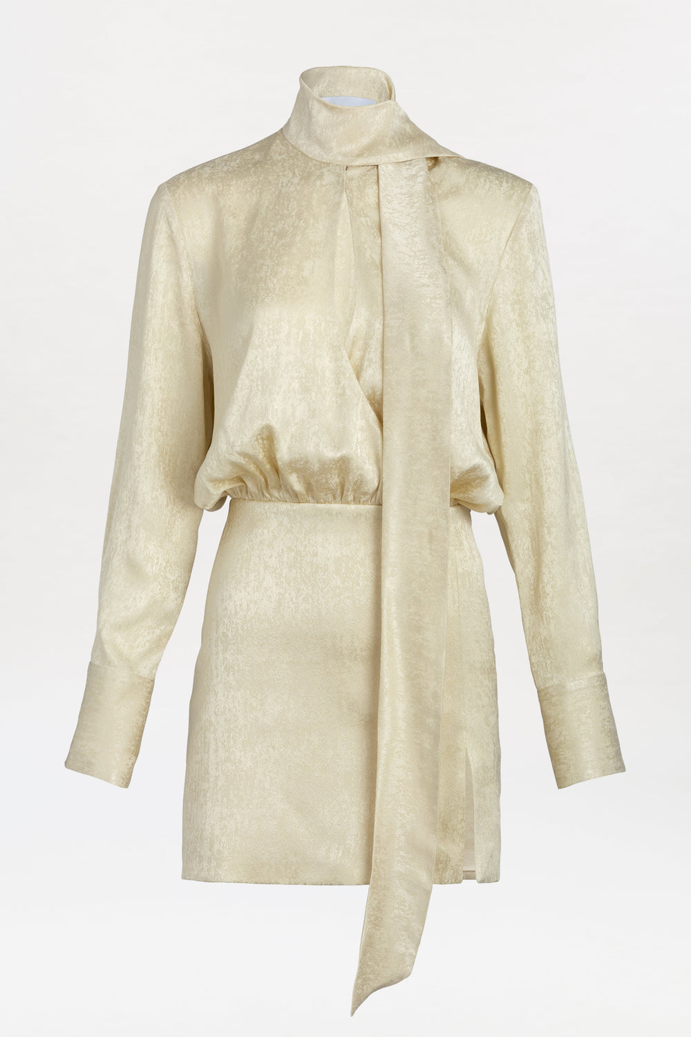 The Imelda Dress is a gold metallic long-sleeve mini dress with a high neck and attached scarf detail, featuring a fitted waist and a slight sheen, displayed on a plain white background.
