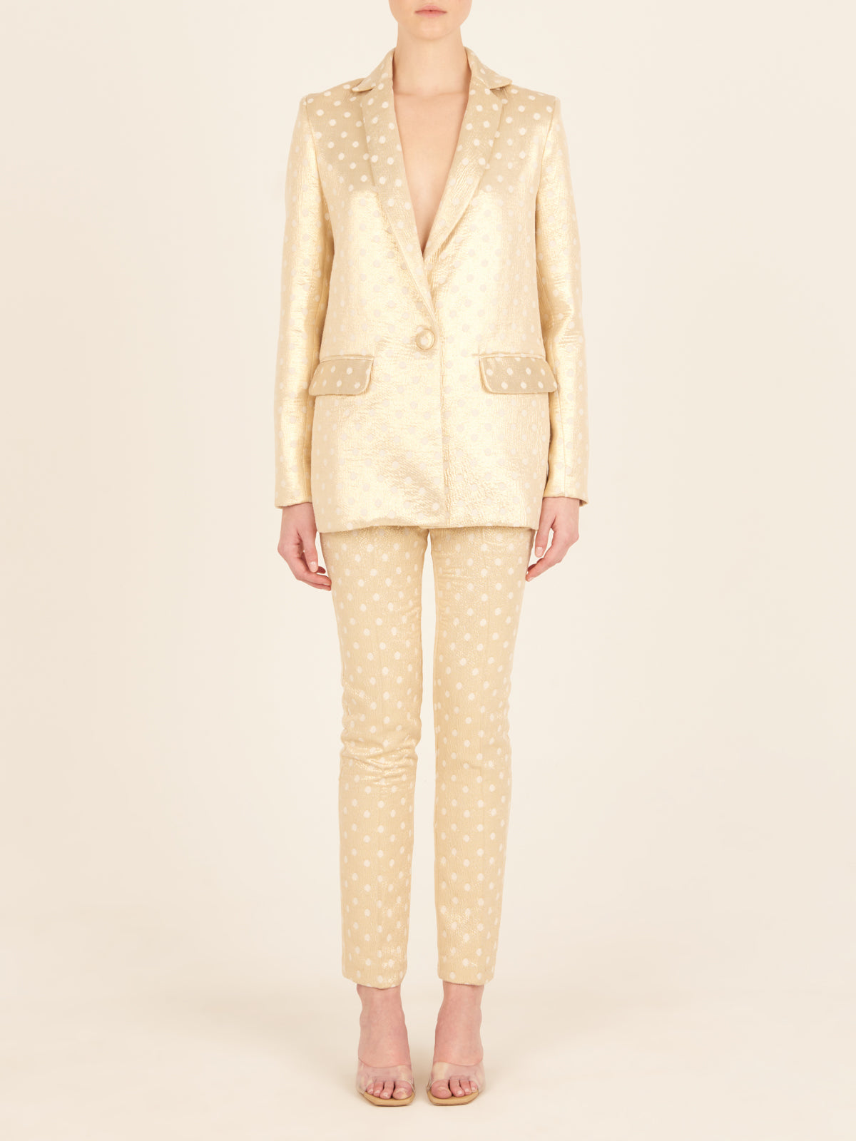 A Sube blazer with polka dots and a gold belt available for Fall 2023.