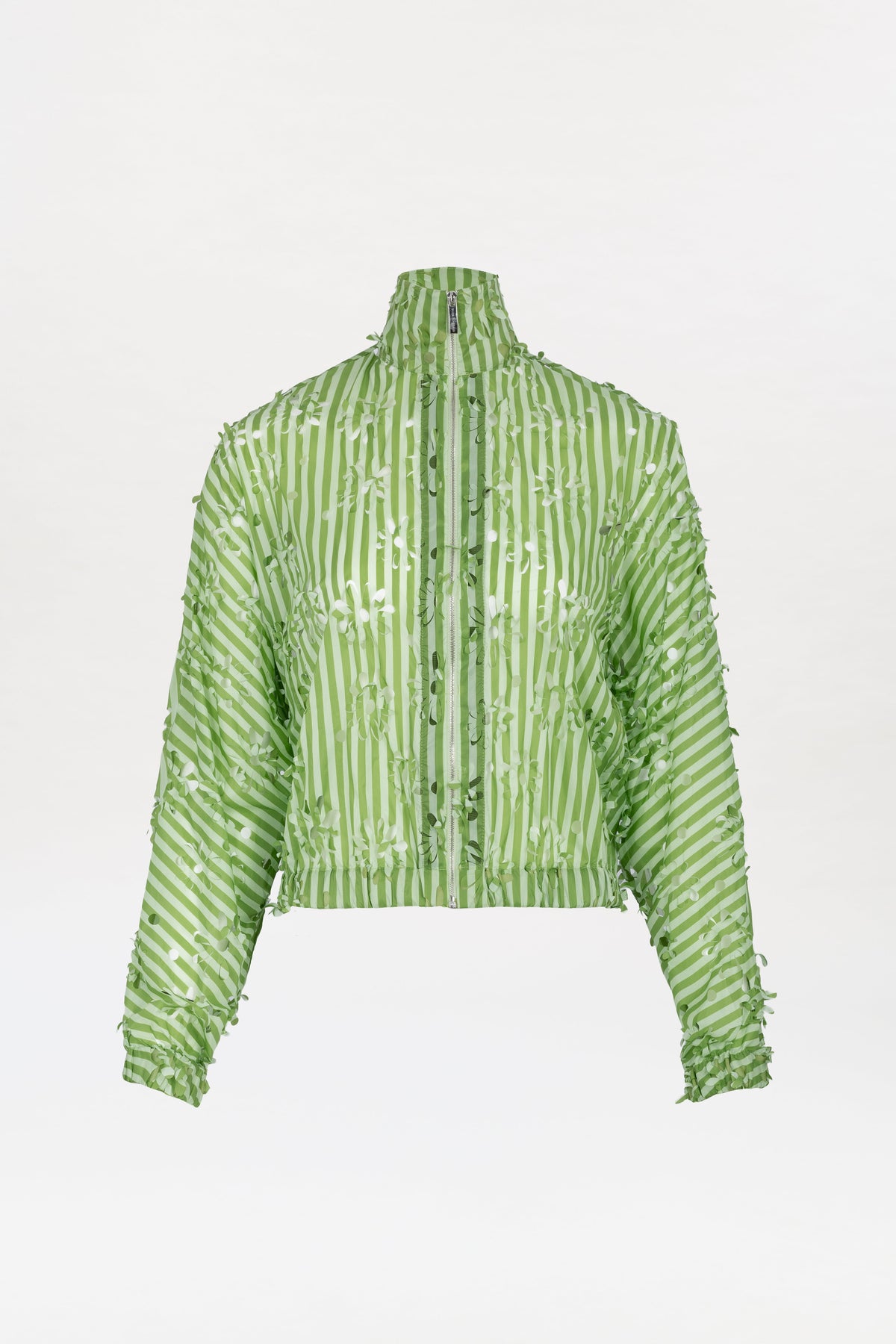 The Randy Jacket is a light green, long-sleeve cropped jacket with vertical white stripes and a high collar, featuring a unique textured pattern that resembles small scattered leaves.