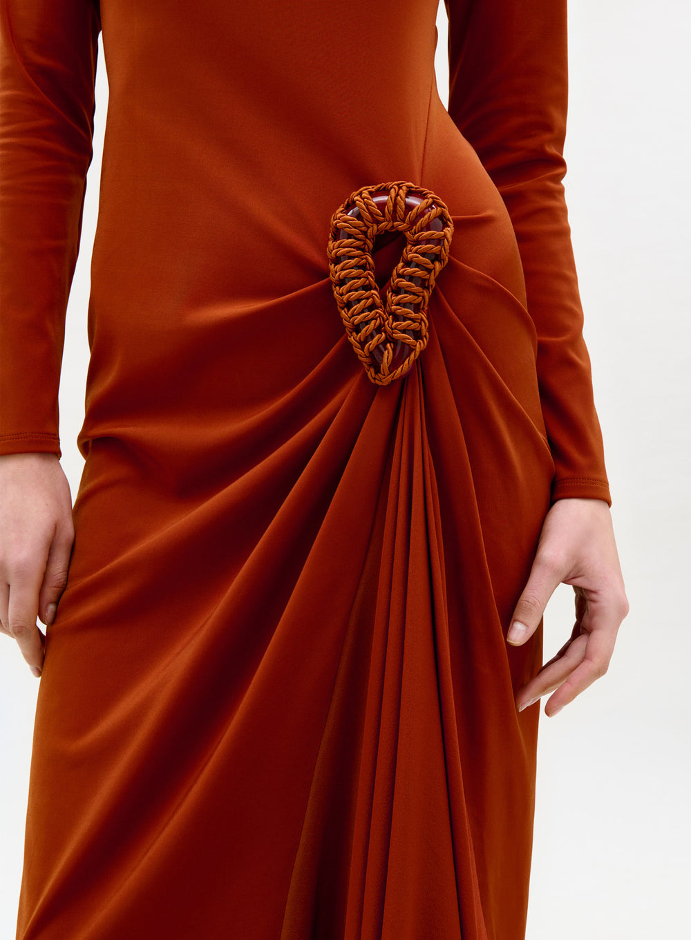 Brown dress with a unique back design on a white background