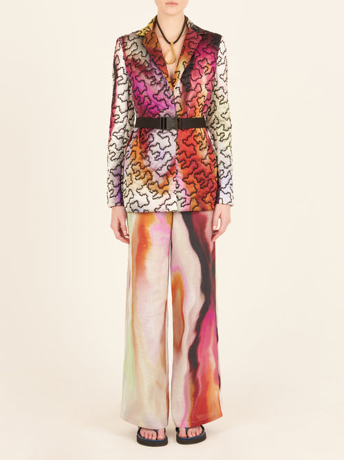 A Yarah Jacket Iridescent Marble with a belt and printed florals.