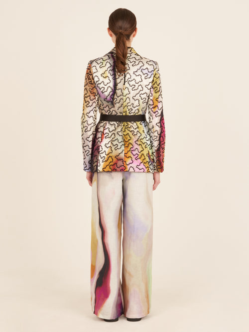 A Yarah Jacket Iridescent Marble with a belt and printed florals.
