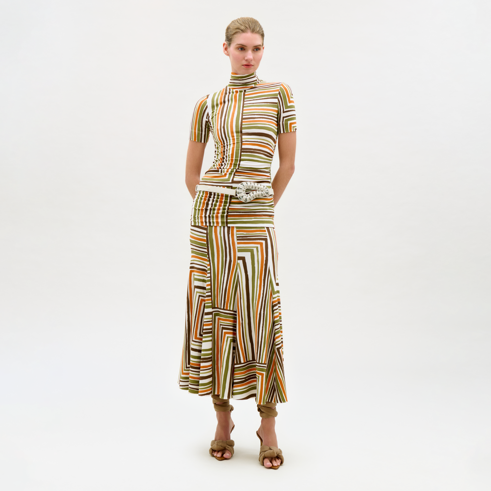 Woman wearing a patterned dress on a white background