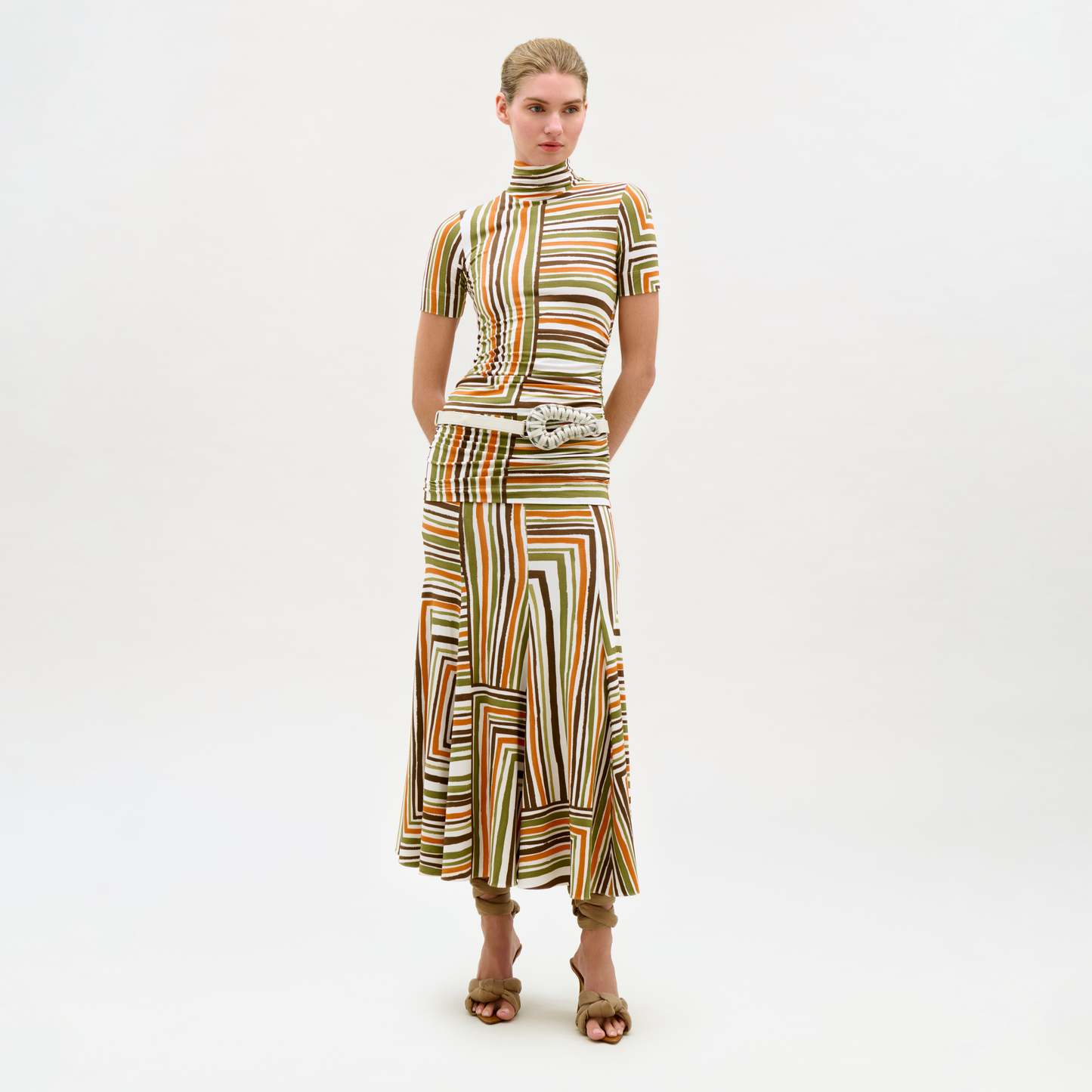 Woman wearing a patterned dress on a white background
