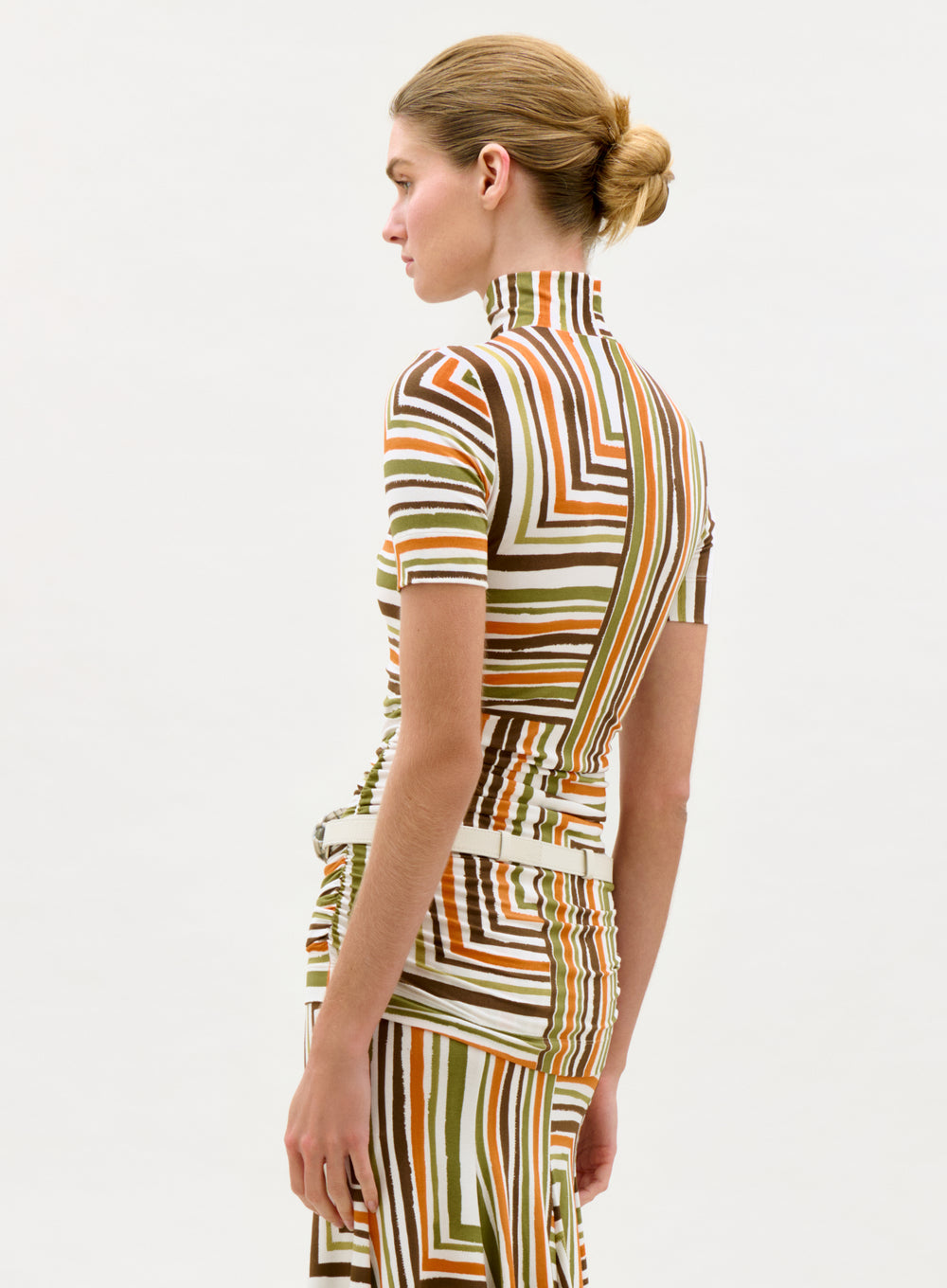 Woman wearing a patterned dress on a white background