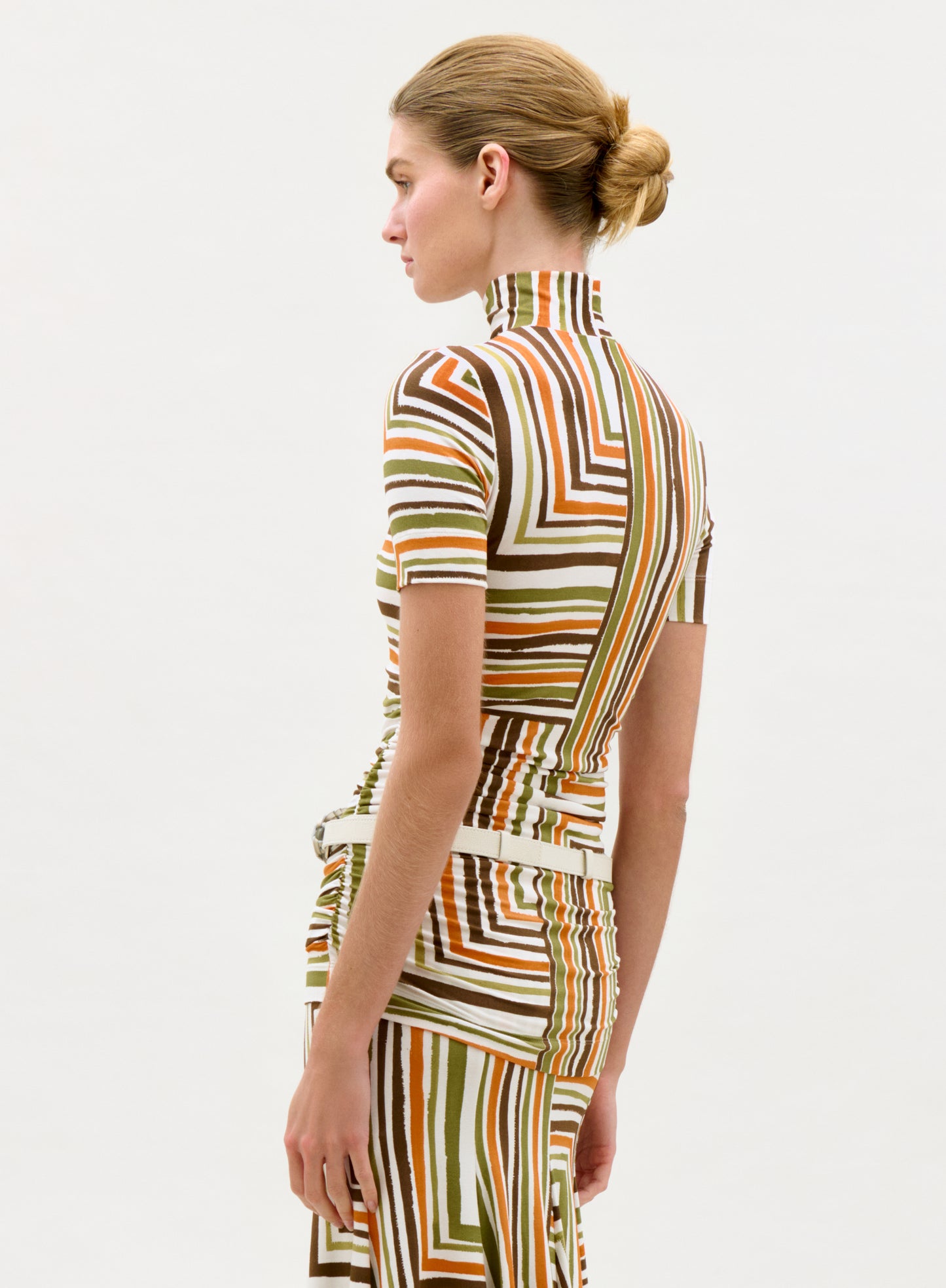 Woman wearing a patterned dress on a white background