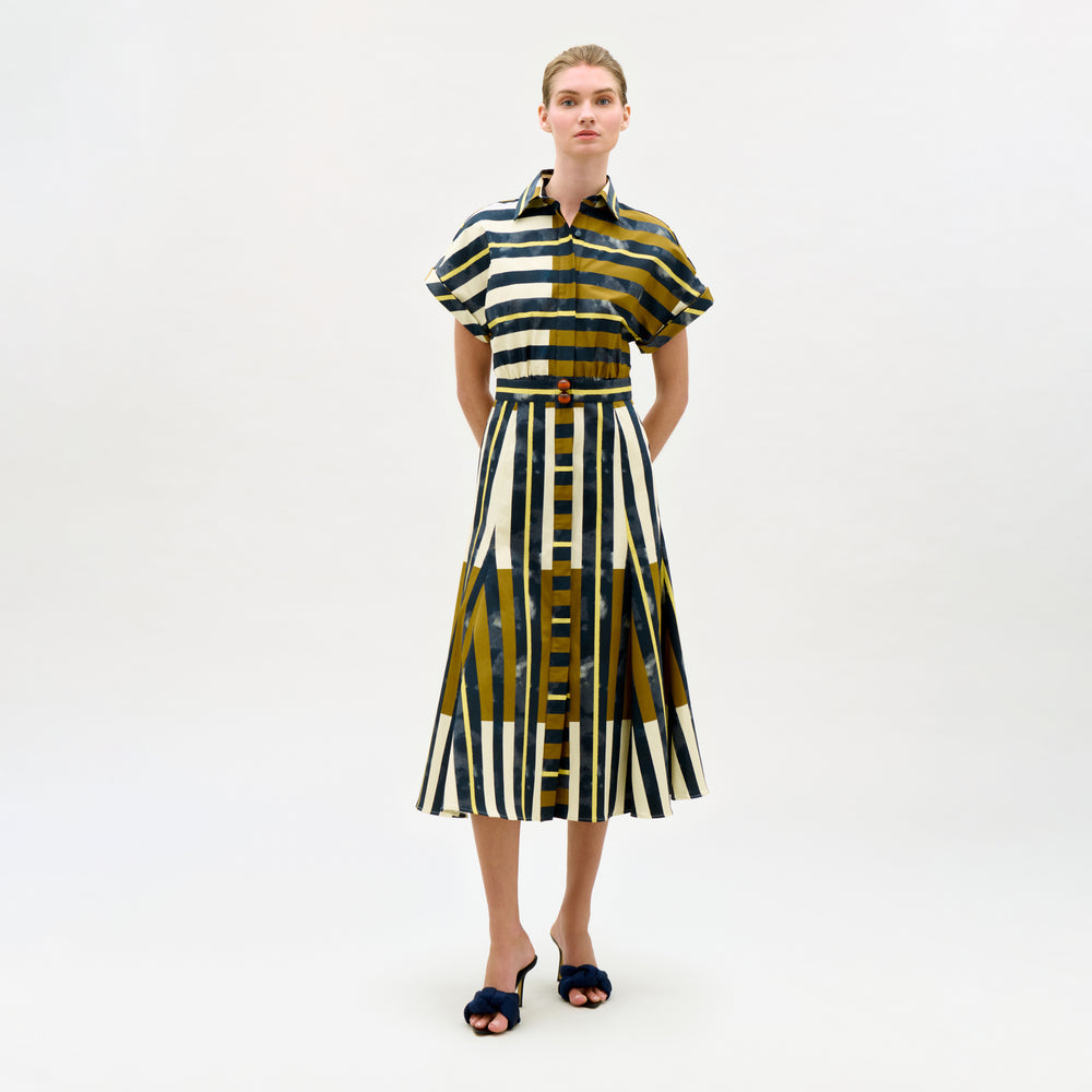 Woman wearing a patterned dress on a white background