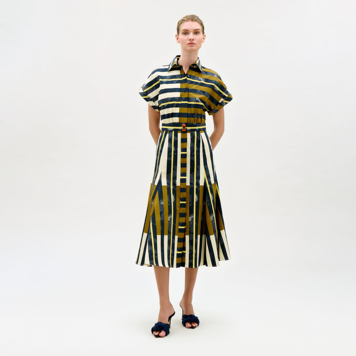 Woman wearing a patterned dress on a white background