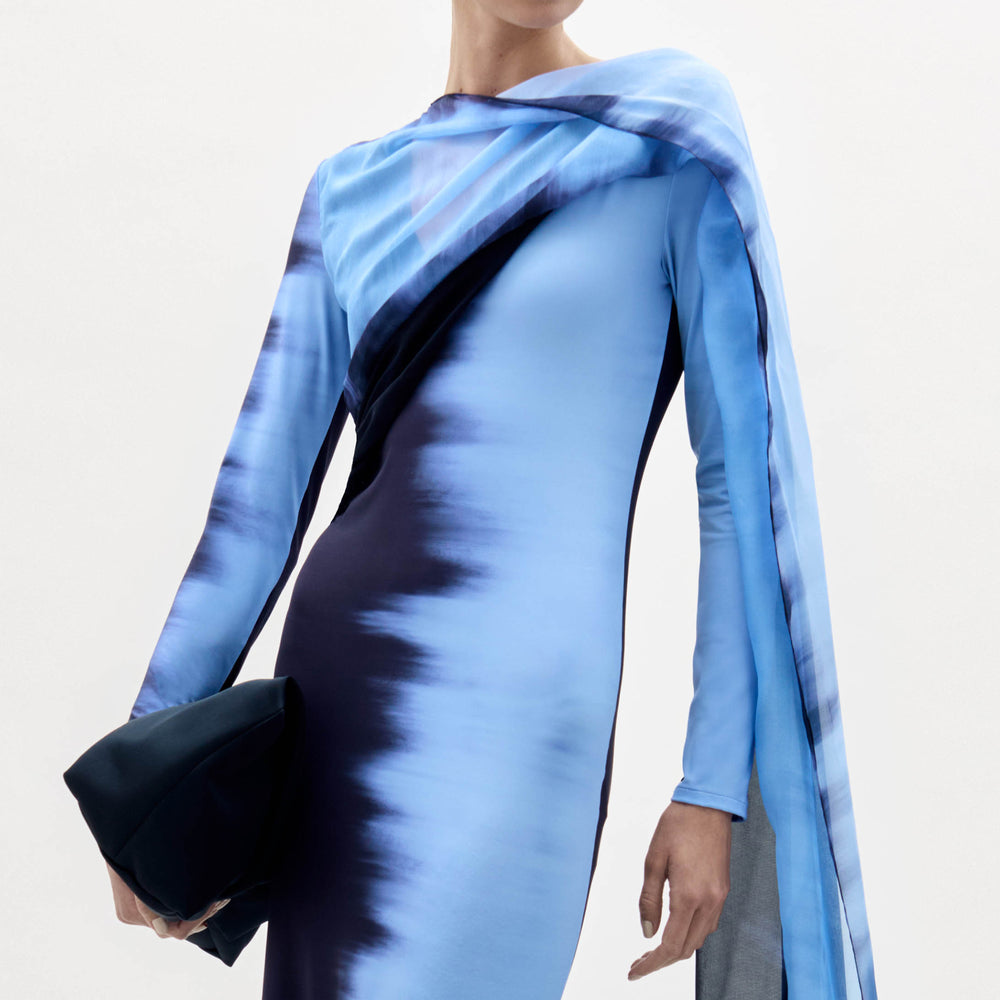 Blue and black patterned dress with a plain background